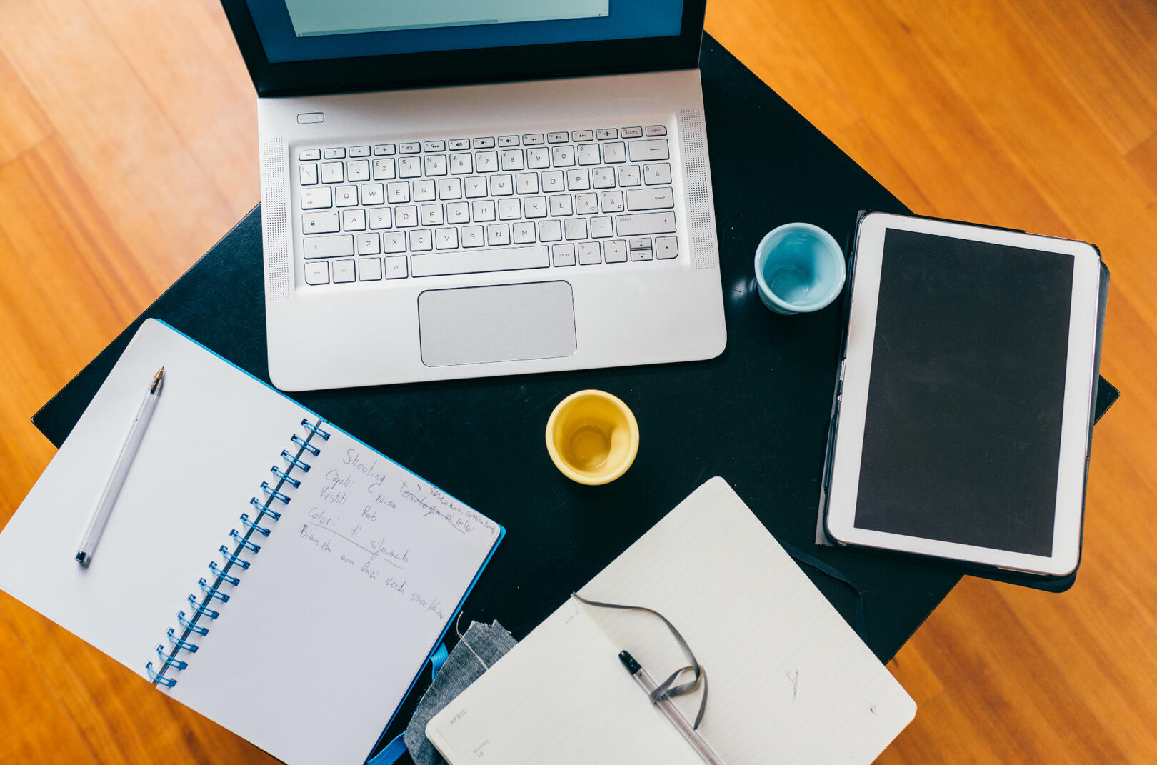 Laptop and notebooks on desk
